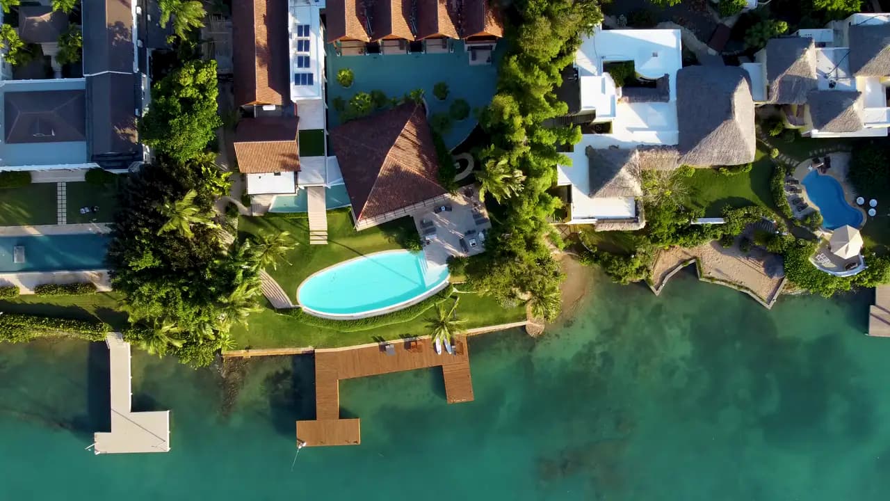 A lakeside home with a pool and jetty